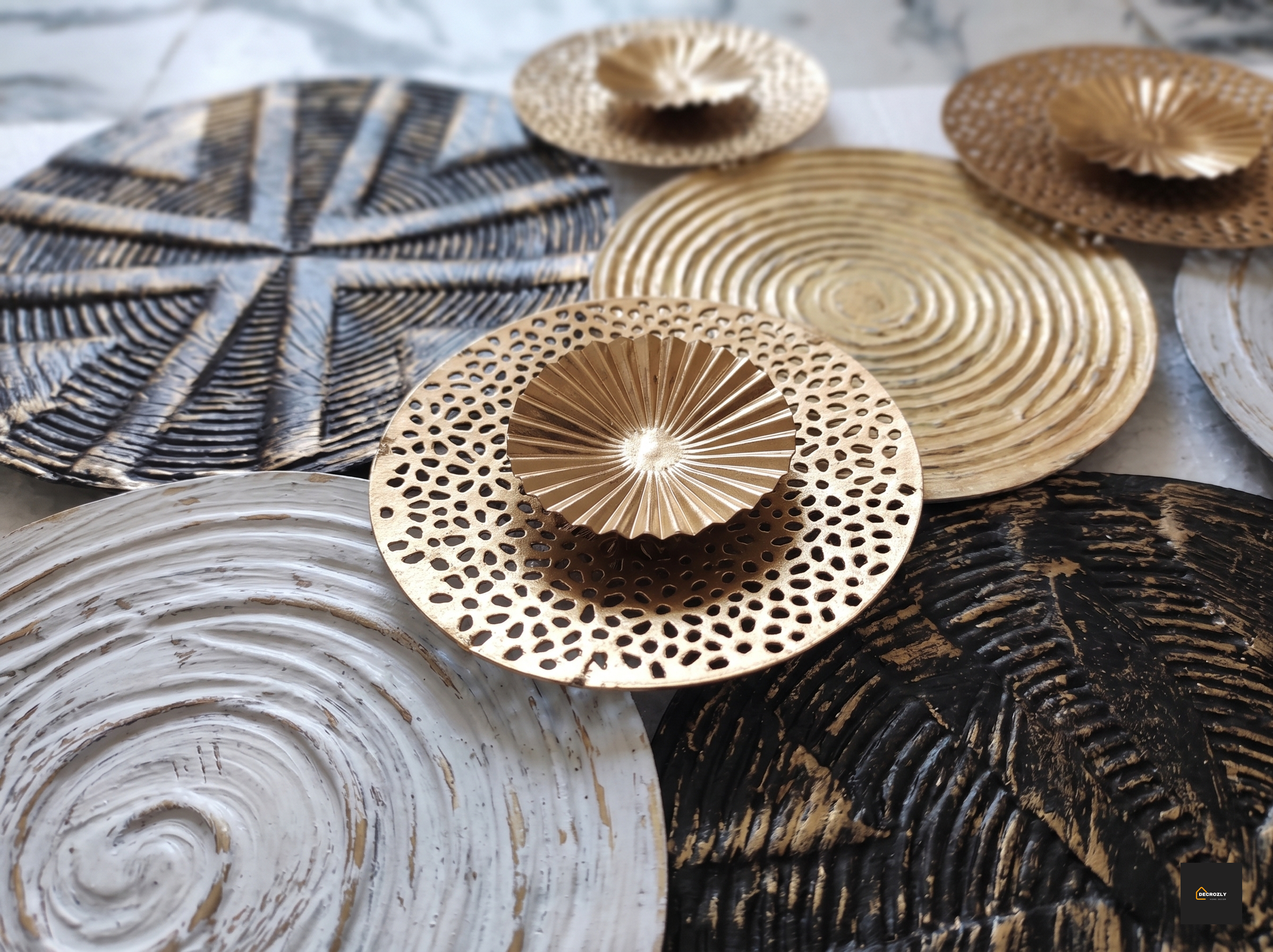 Decorative plates with intricate designs on a textured surface