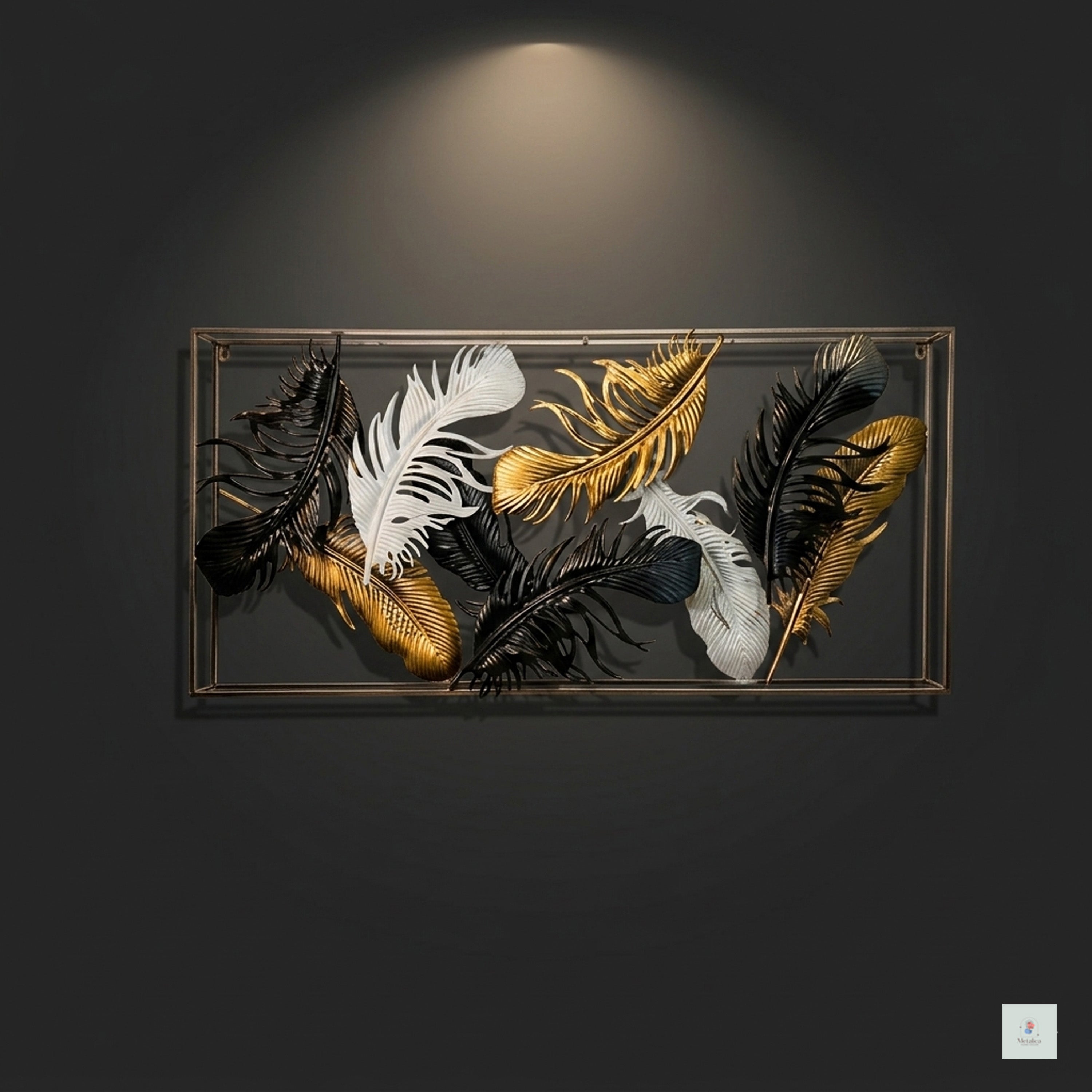 Decorative wall art with feathers in a metallic frame on a dark background