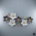 Decorative floral arrangement with black, white, and gold flowers on a gray background