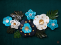 Decorative flowers with gold accents on a dark green background