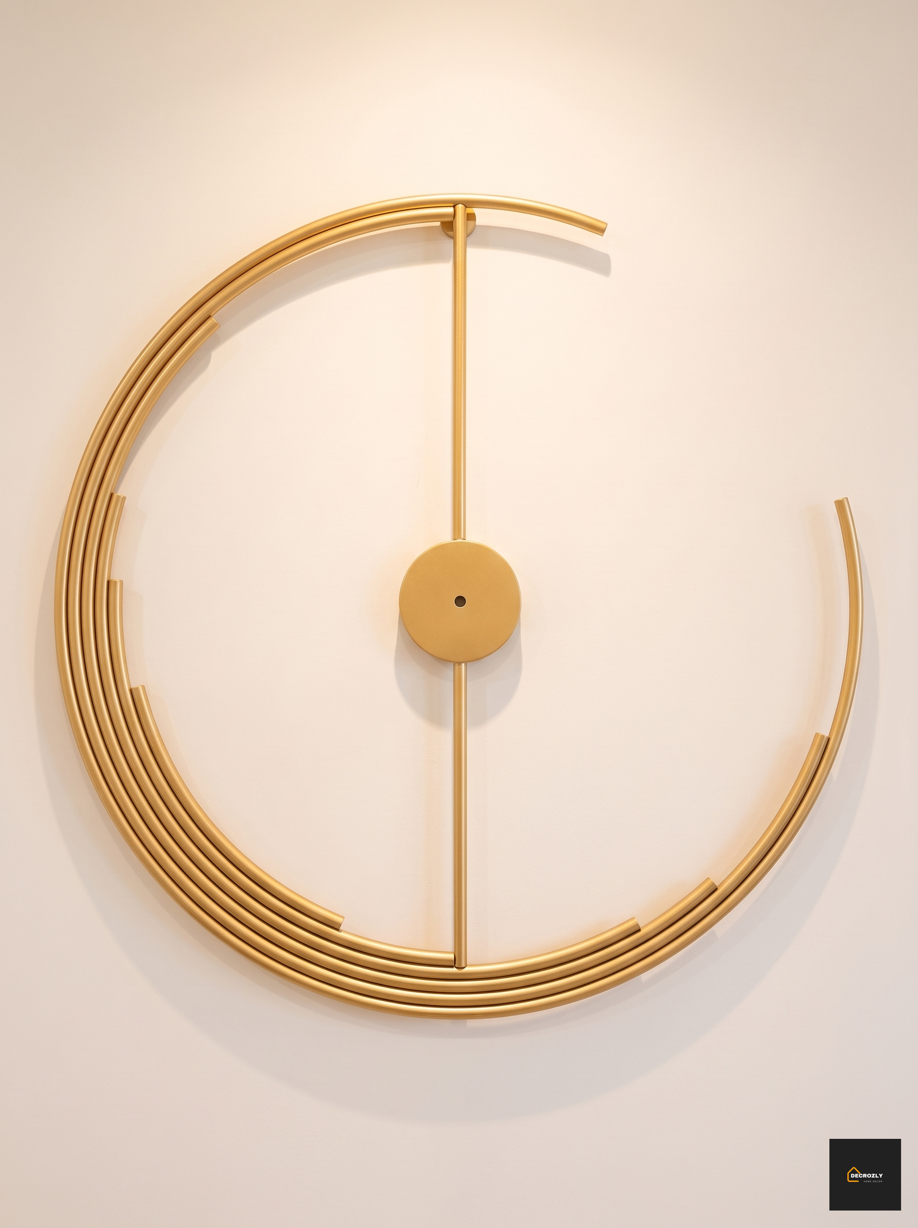 Modern gold wall clock with a minimalist design on a beige wall.