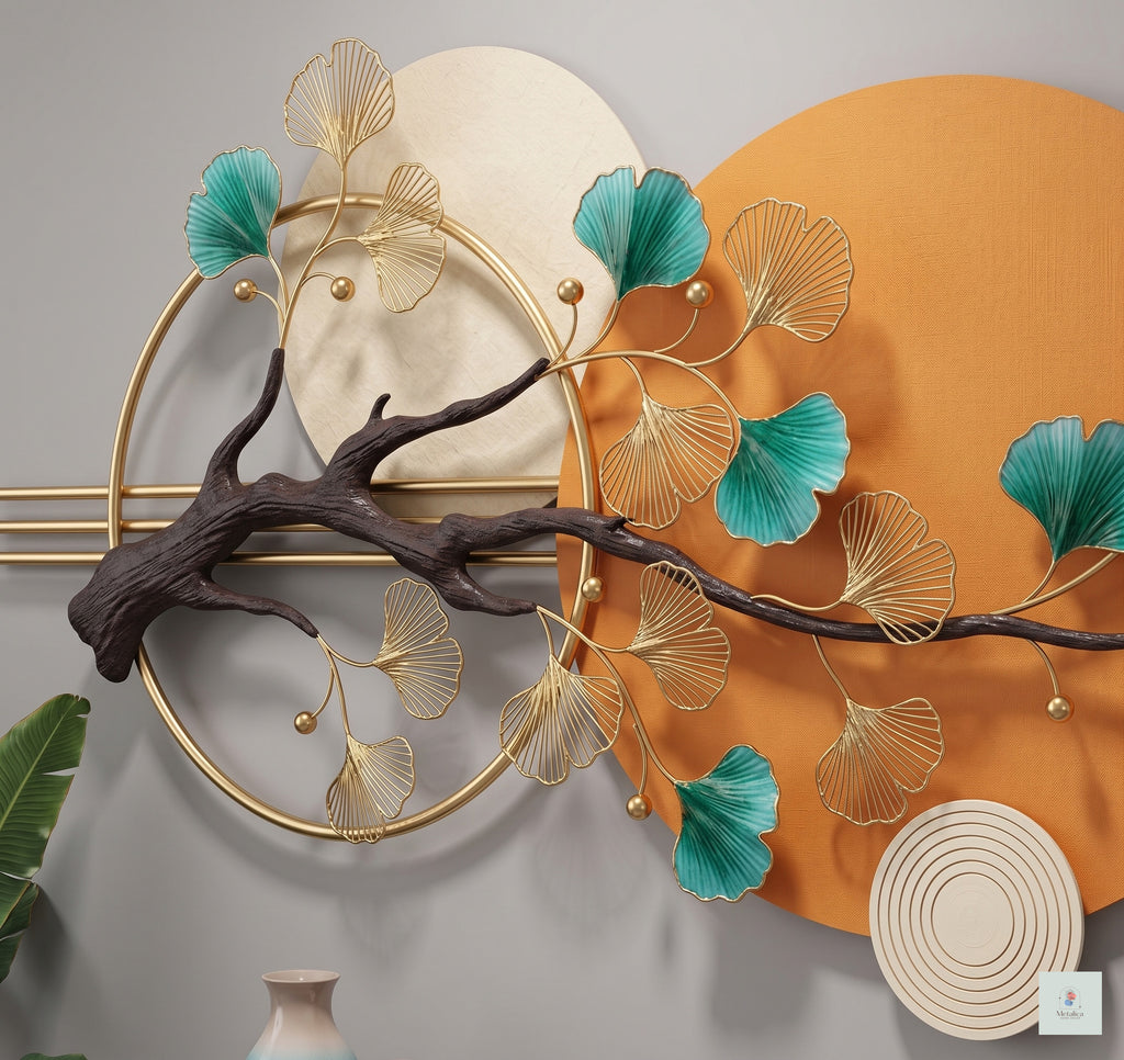 48x24 modern Zen ginkgo leaf wall art, botanical metal sculpture with gold and teal leaves on orange and grey circular background for living room decor.