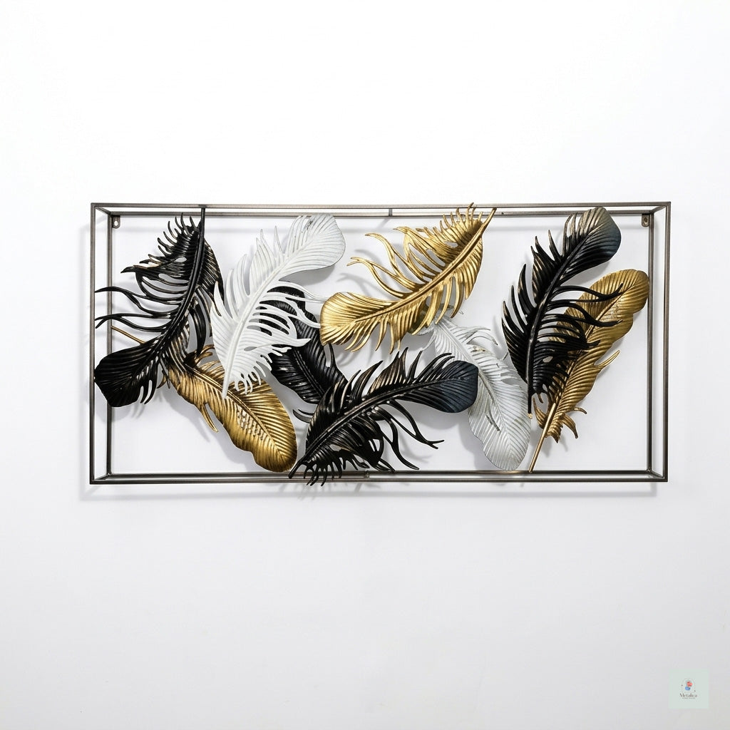 Decorative wall art with black, gold, and white feathers in a metallic frame on a white background
