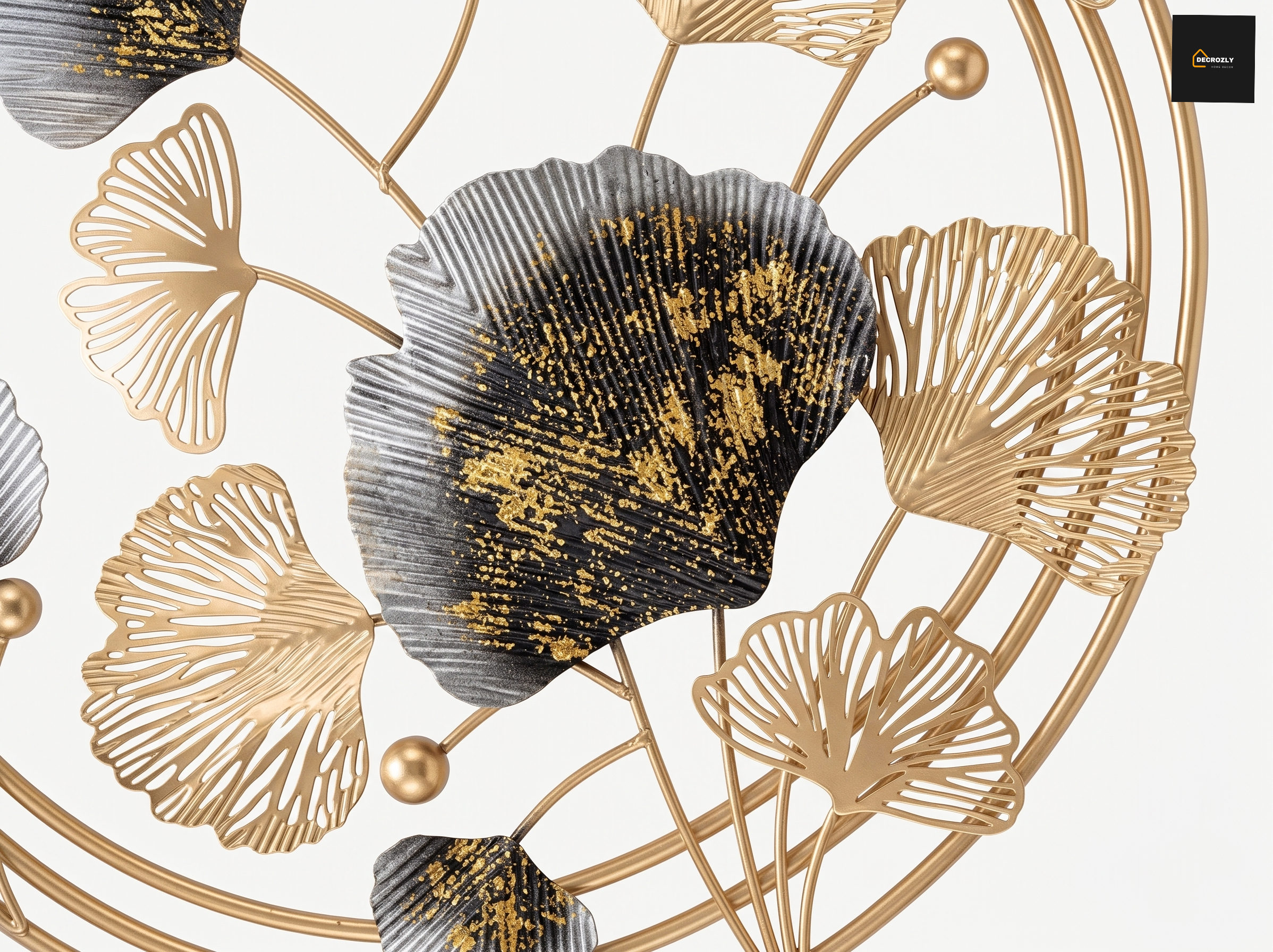 Decorative wall art with gold and black leaf patterns on a white background