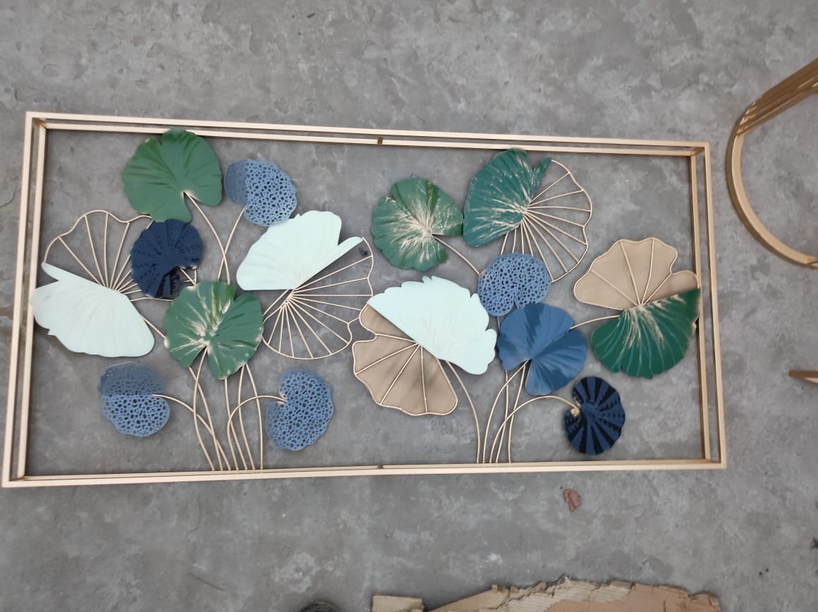 Decorative wall art with leaf patterns on a concrete surface
