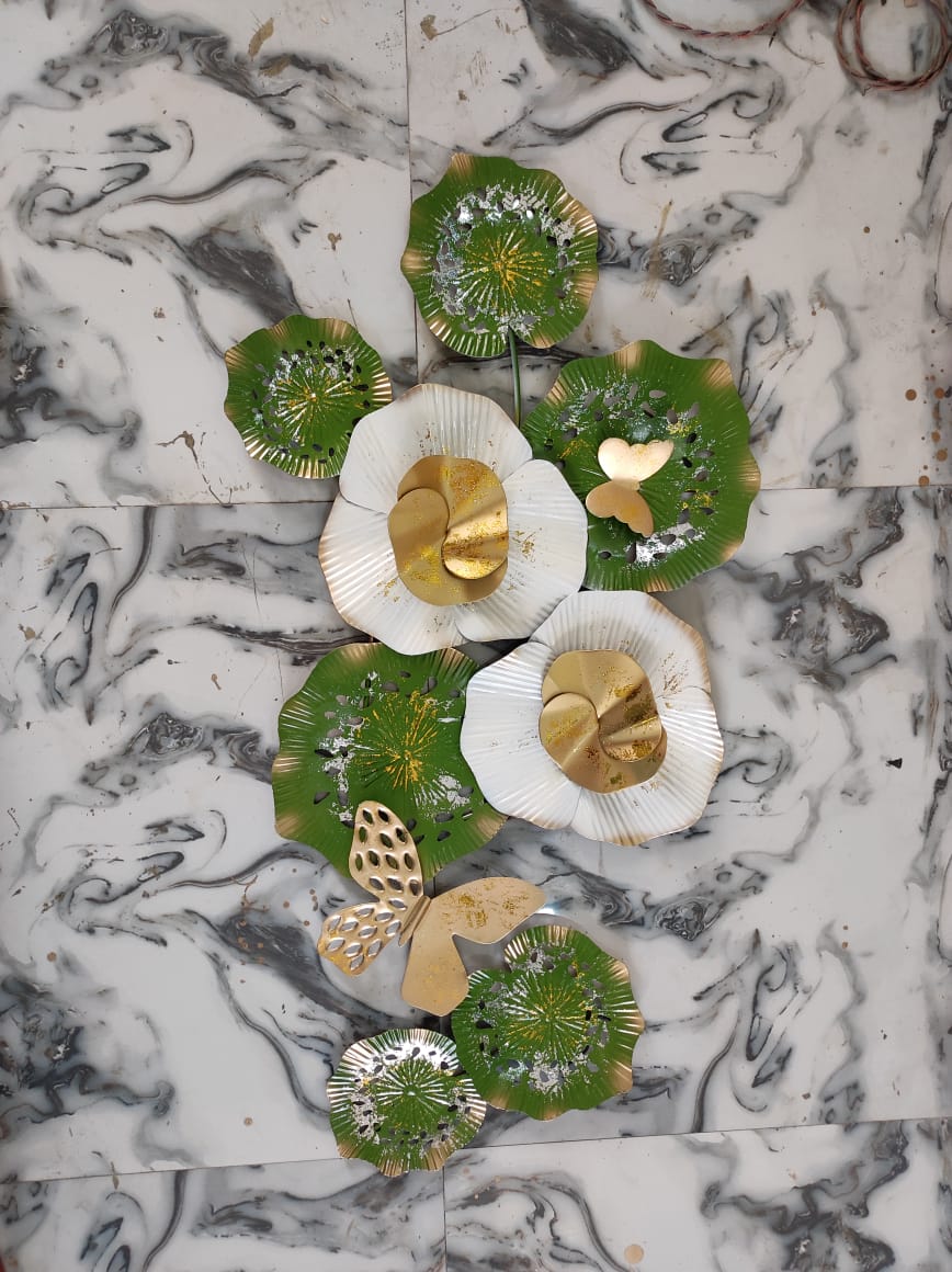 Decorative plates with green and gold designs on a marble surface